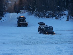 Chena River Ice Bridge and two front wheels of a car fallen through the ice.