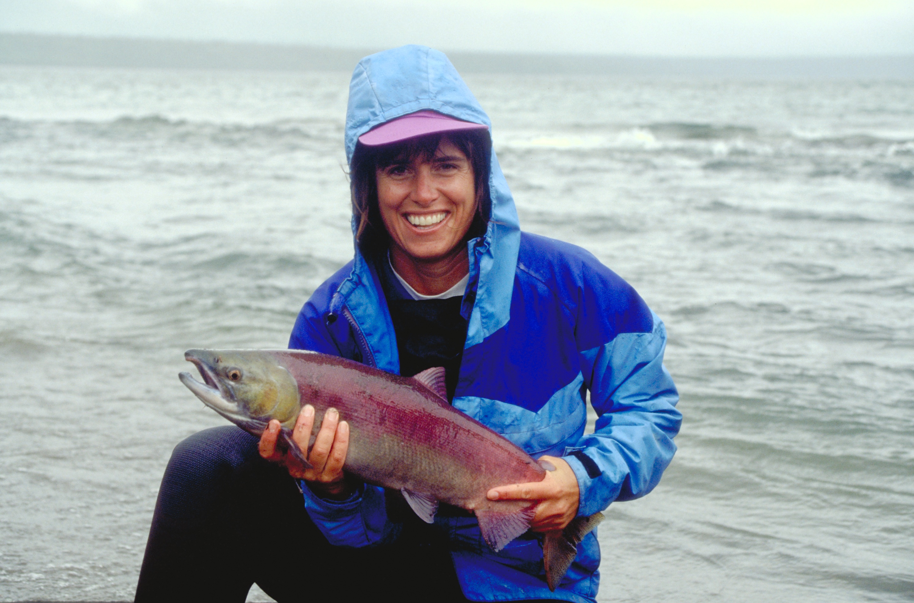 Alaskan salmon Alaskan salmon held by a woman with a big smile and a blue rain coat
