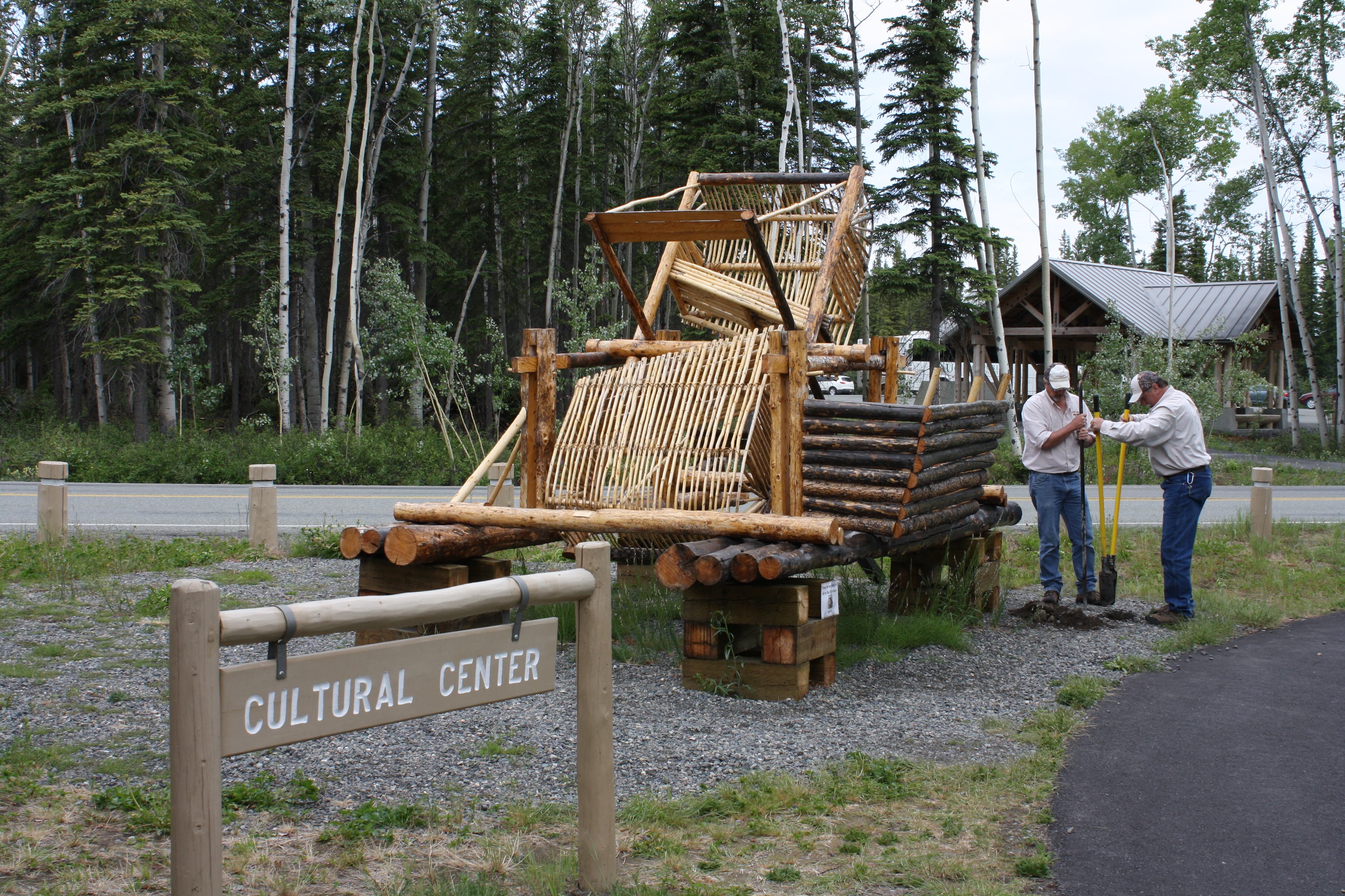 Gregory Sports and Bob Chase of the Copper River Princess Wilderness Lodge's maintenance team work on digging a hole for the new sign in front of the fish wheel. 