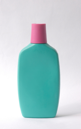 teal bottle with pink lid and no label resembling older sunscreen bottles