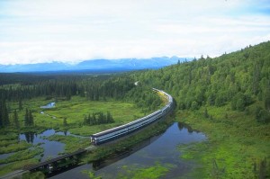 Princess railcars pass a pond in Alaska