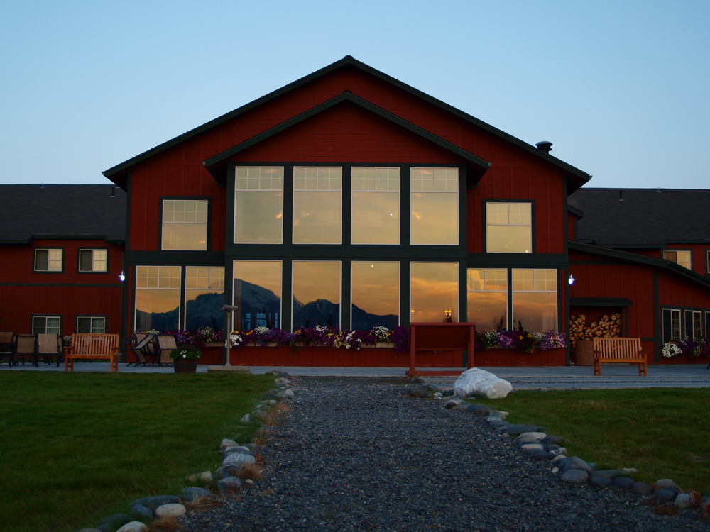 Majestic Copper River Princess Lodge with sunset mountain reflected in windows- Princess Lodges