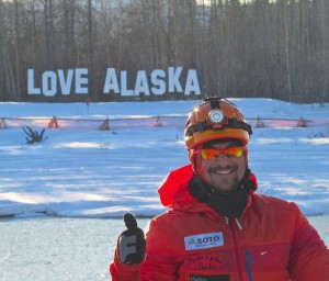 Koitzsch in front of the "Love Alaska" sign