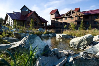 Upper building exterior photo at midday at Denali Princess Riverside Lodge