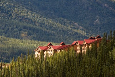 Denali Alaska Wilderness Lodge with sweeping tree-covered hills in the distance