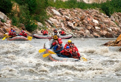 Nenana River Paddle Rafting - people enjoying white water in a raft with oars