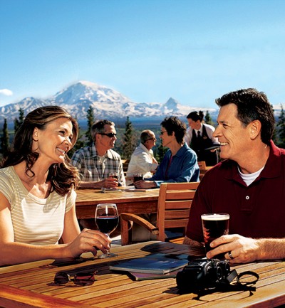 Couple enjoying happy hour on the patio at the Copper River Wilderness Lodge