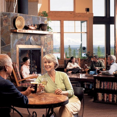 Couple enjoying wine in the Wrangell Room at the Copper River Princess Wilderness Lodge