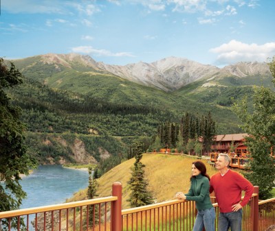 Couple overlooking the river from the deck at Denali Princess Wilderness Lodge