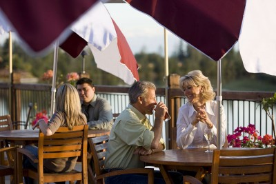 Travelers enjoying he deck at the lodge along side the Chena River