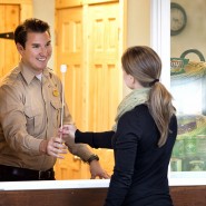 The main lobby of the Mt. McKinley Princess Wilderness Lodge features a slate floor, towering ceilings and Alaskan decor. This lobby connects the Great Room, Grizzly Bar, Gift Shop and the North Great Room in one central place. 