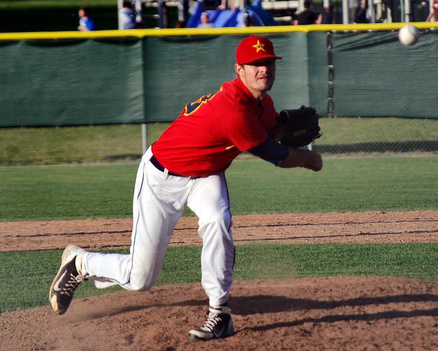 A baseball pitcher throws a pitch.