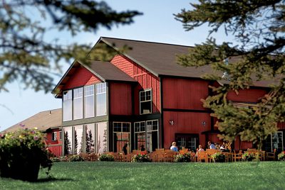 Exterior of Copper River Princess Wilderness Lodge and its wall of windows.