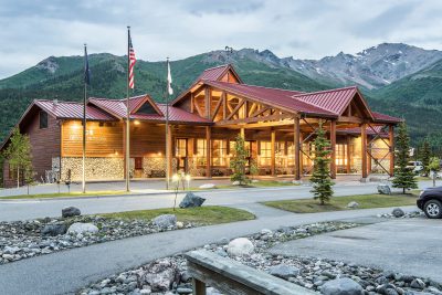 Exterior photo of the Denali Lodge taken at dusk.