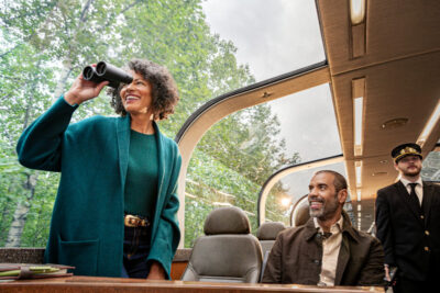 Couple enjoying views from glass-dome rail car